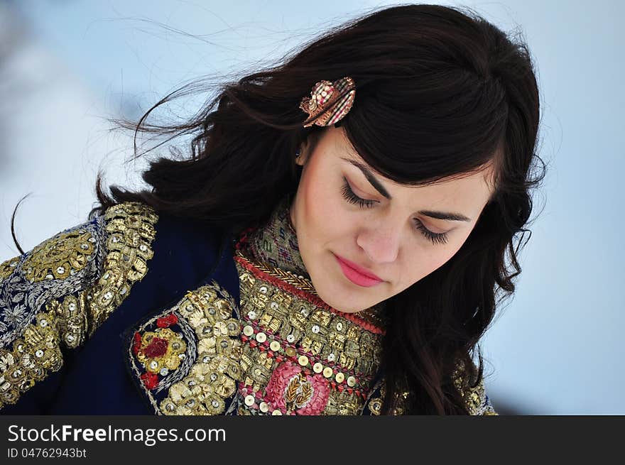 The portrait of a woman dressed in traditional Bulgarian costume.