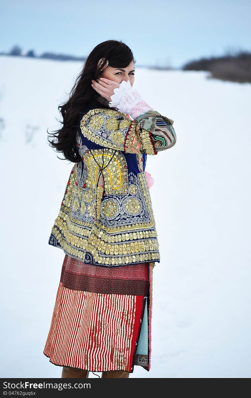 The portrait of a woman dressed in traditional Bulgarian costume.