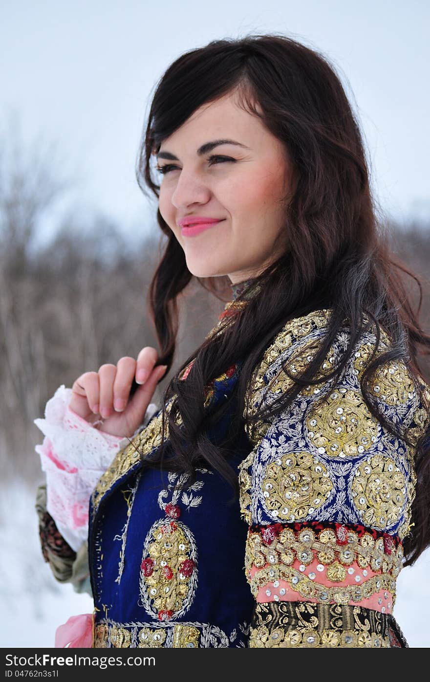 The portrait of a woman dressed in traditional Bulgarian costume.