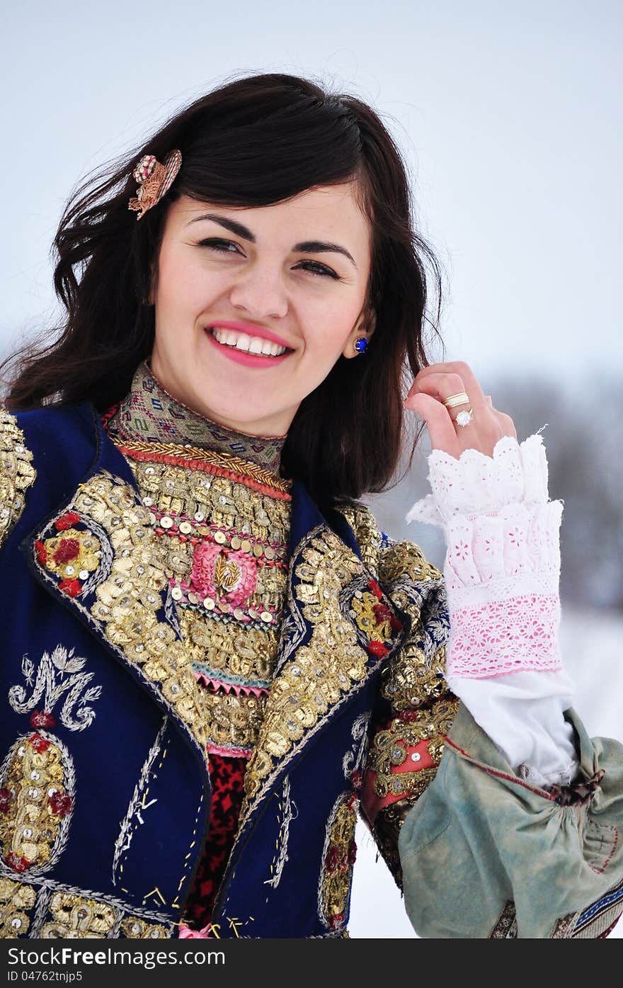 The portrait of a woman dressed in traditional Bulgarian costume.