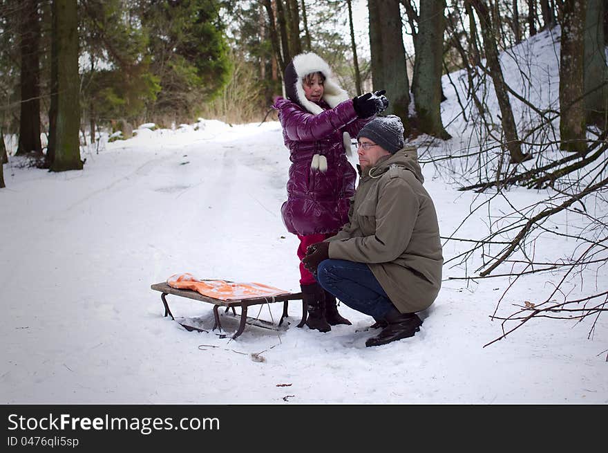 Daughter playing with father in winter