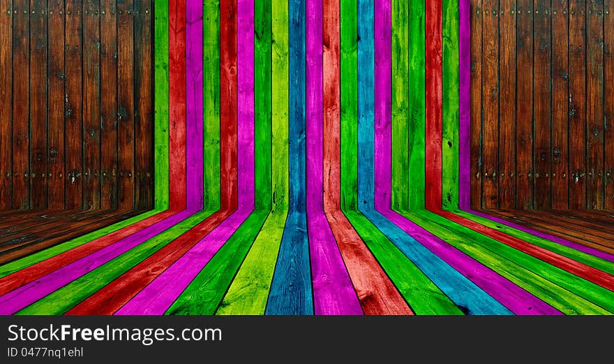 A creative wooden room with multicolored and brown planks as a background. A creative wooden room with multicolored and brown planks as a background