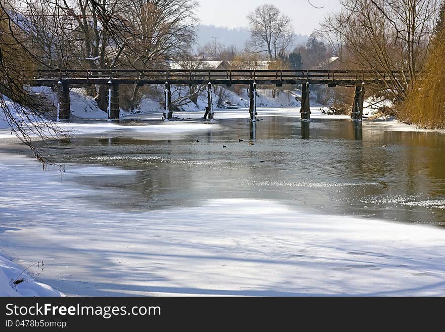 Frozen river with bridge