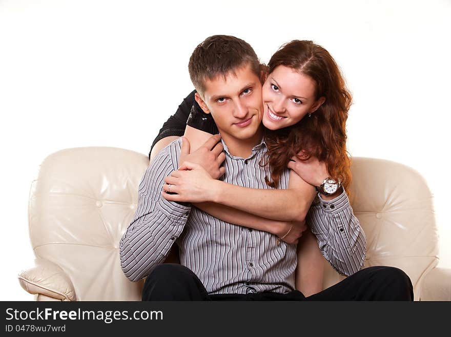 Young women hugging her boyfriend and look camera. Young women hugging her boyfriend and look camera