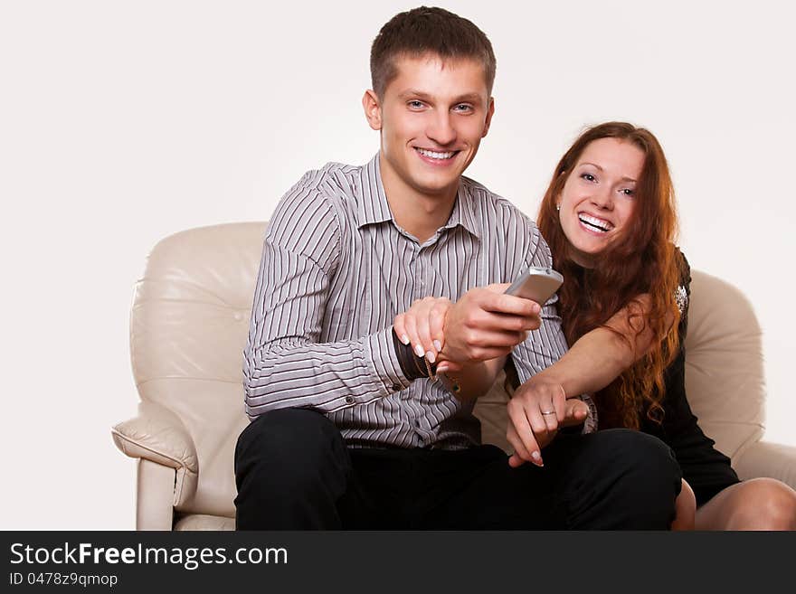 Family sitting in front of TV on the couch