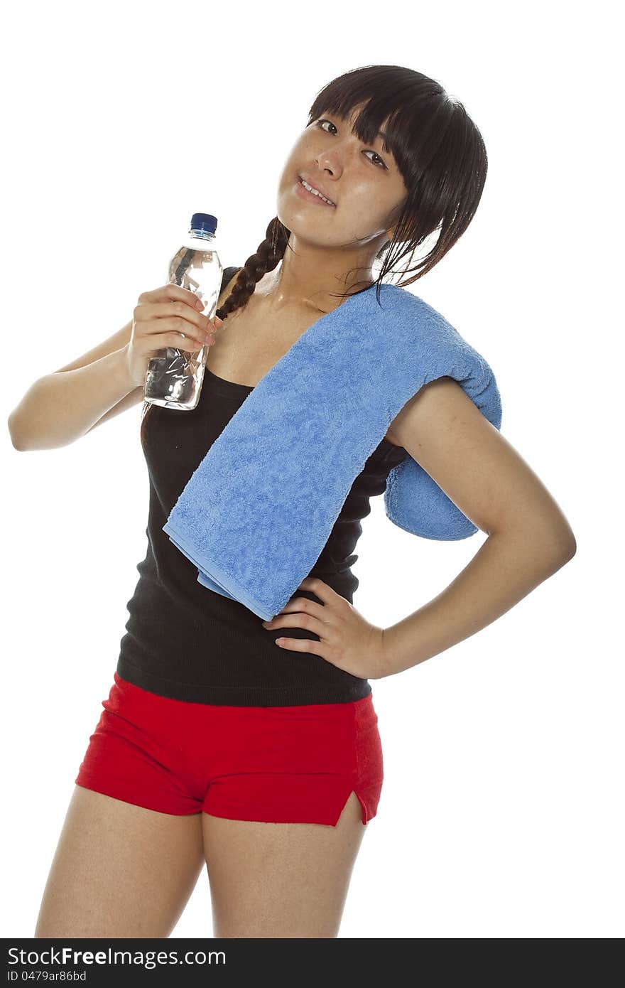 Young Asian woman with a bottle of water and towel after being working out. Isolated on white