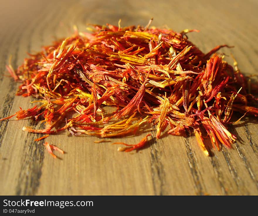 Pile of saffron on wooden background ( close up)