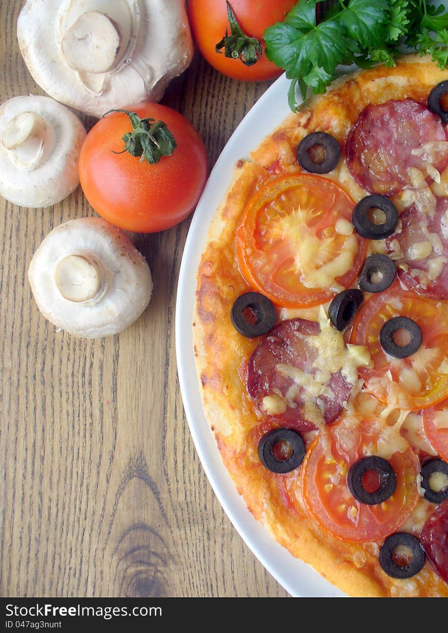 Pizza with tomato, sausage, mushrooms, cheese, oli