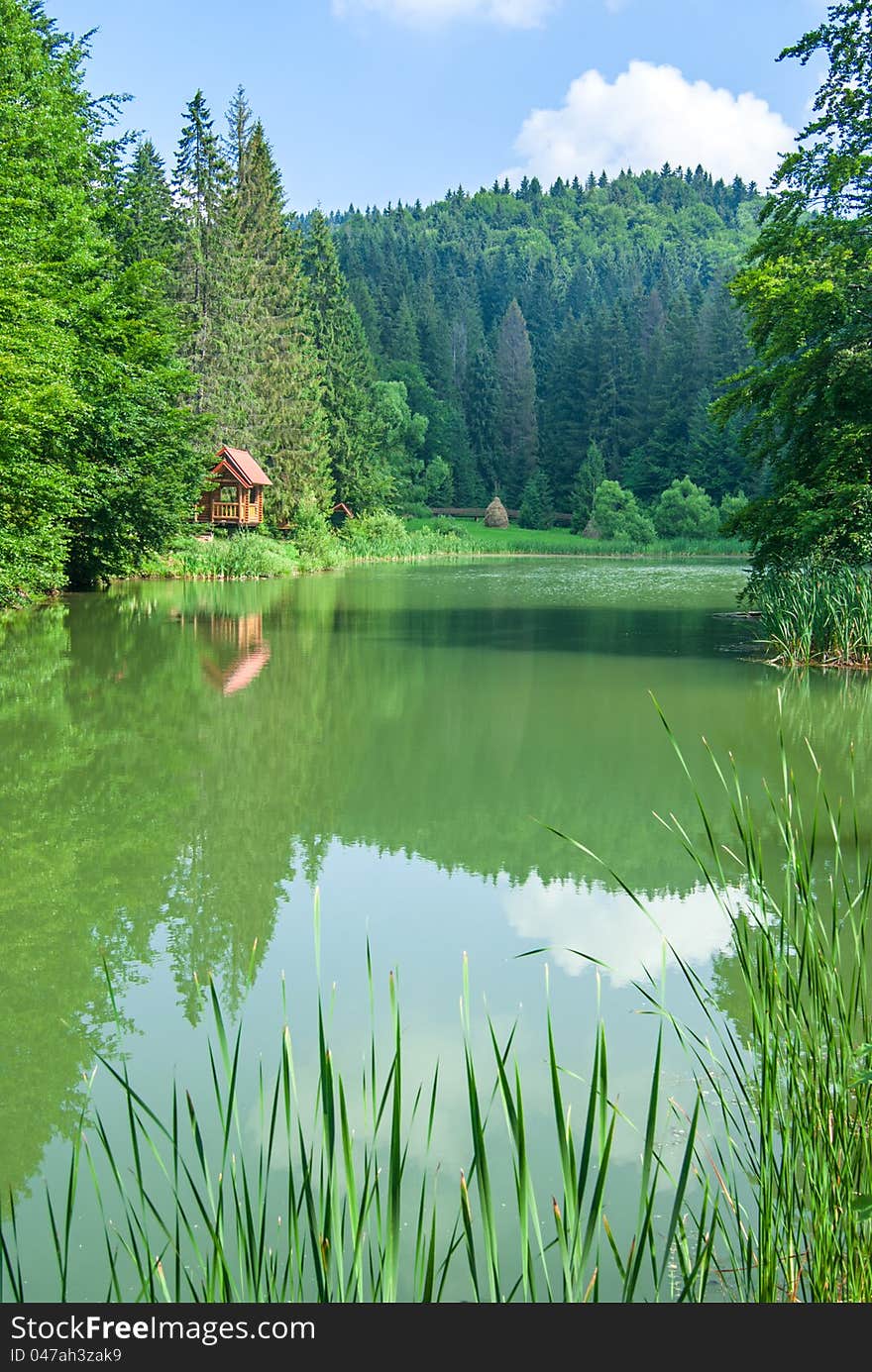 Beautiful wooden house on lake in wood