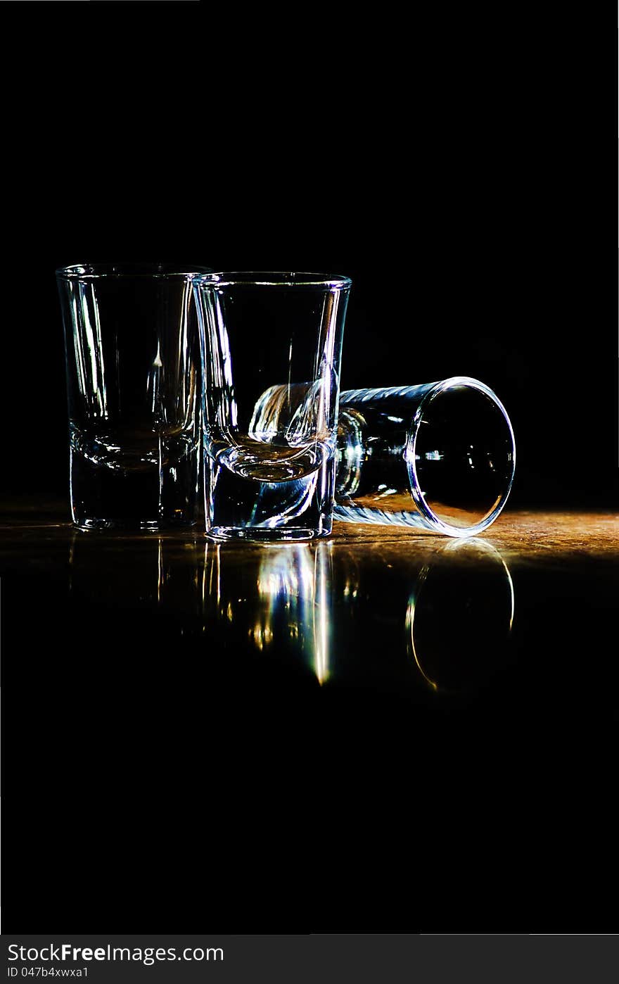 Three glasses on the bar in a beam of light