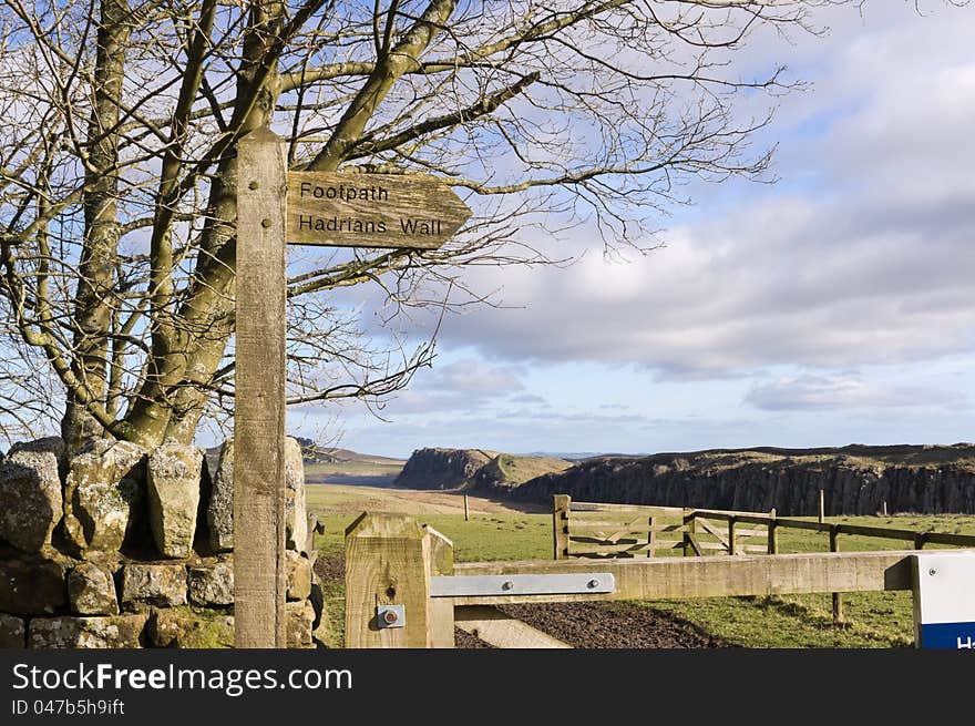 Sign post to Hadrians Wall with Steel Rigg and Crag Lough behind. Sign post to Hadrians Wall with Steel Rigg and Crag Lough behind