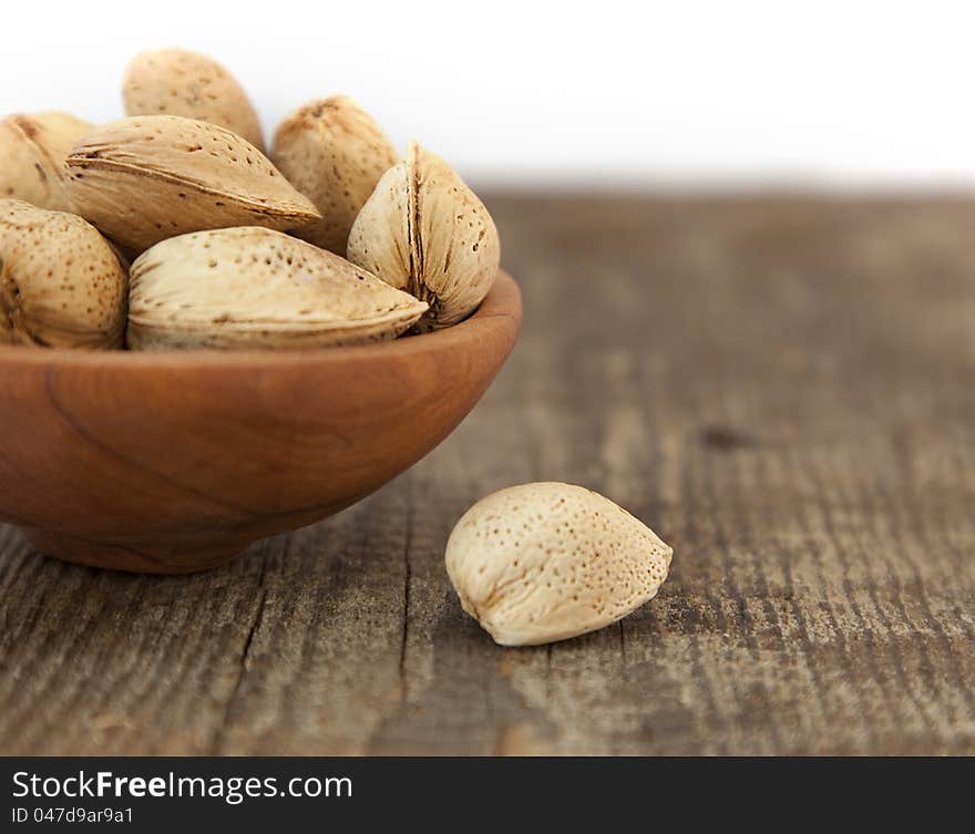 Almonds. Pile in the plate. Shallow focus