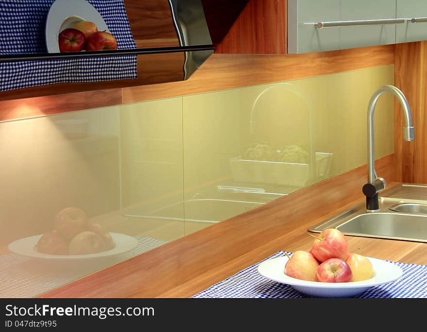 A beautiful reflections in new kitchen with apples for decoration. A beautiful reflections in new kitchen with apples for decoration.