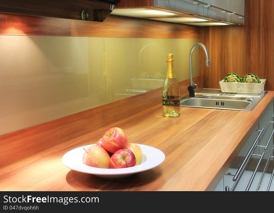 Beautiful interior of kitchen with apples for decoration, a bottle of vine and vegetables. Beautiful interior of kitchen with apples for decoration, a bottle of vine and vegetables.