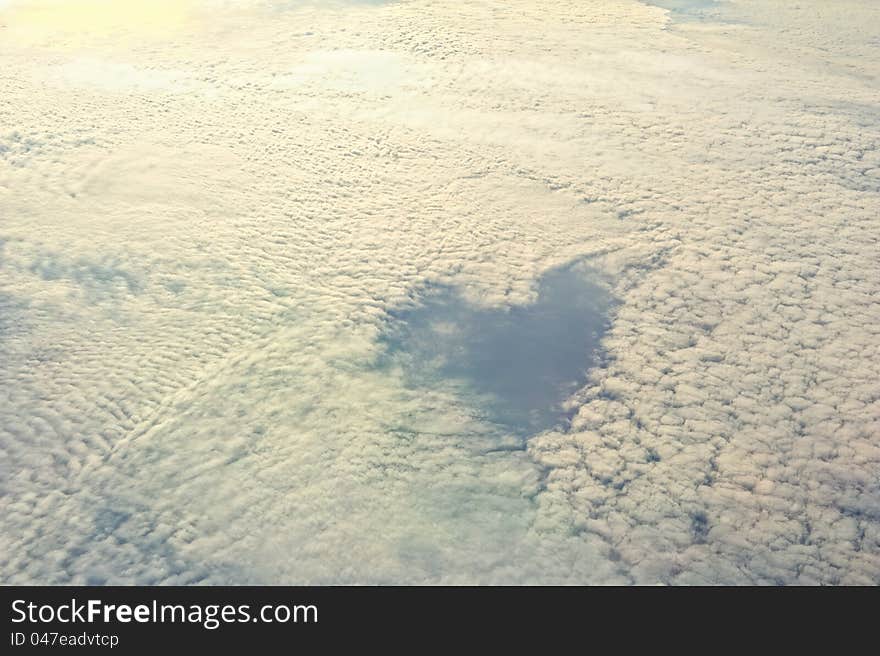 Fluffy clouds and in the middle a heart contour. Fluffy clouds and in the middle a heart contour