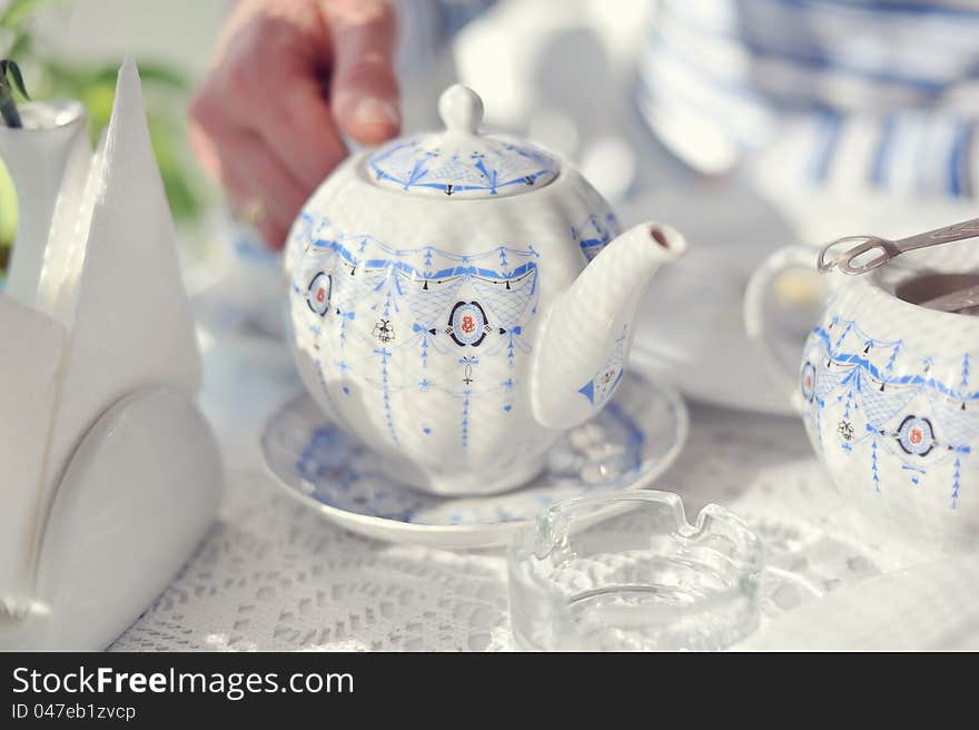 Color porcelain cup with tea and a saucer