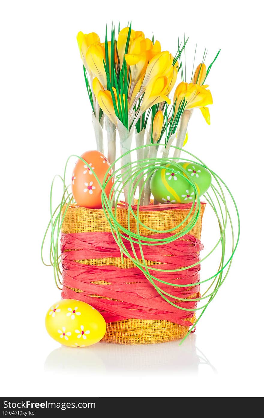 Easter eggs and spring crocuses in flower pot with bright decoration isolated on white background. Easter eggs and spring crocuses in flower pot with bright decoration isolated on white background