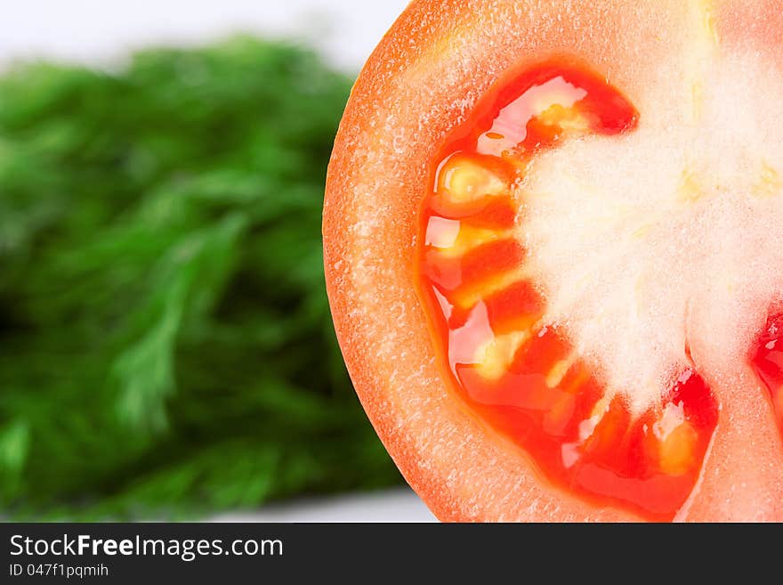 Closeup tomato with green dill background