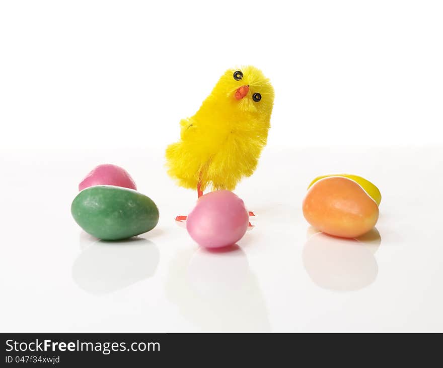 Cute Easter chicken on white background with candy and copyspace. Cute Easter chicken on white background with candy and copyspace