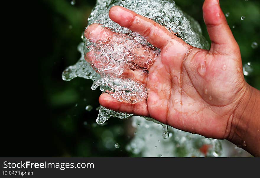 Fresh clean and pure bubbling water splashing on hand. Fresh clean and pure bubbling water splashing on hand