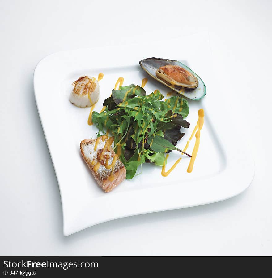 Salmon mussel and oyster seafood steak with variety of vegetables the restaurant menu