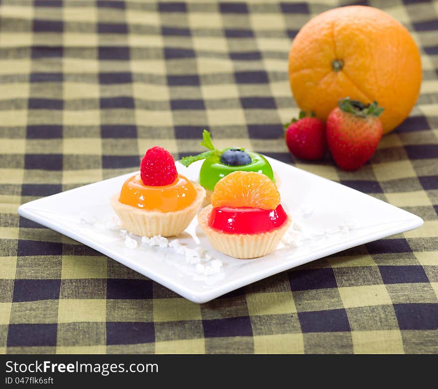 Jelly cupcake decorates with raspberry orange and blueberry. Jelly cupcake decorates with raspberry orange and blueberry