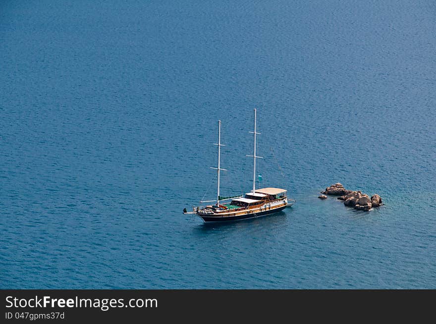 Yatch anchored one of the distant rocks in Antalya-Turkey. Yatch anchored one of the distant rocks in Antalya-Turkey