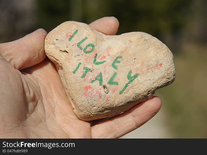 I love Italy, stone heart on a dry hand palm