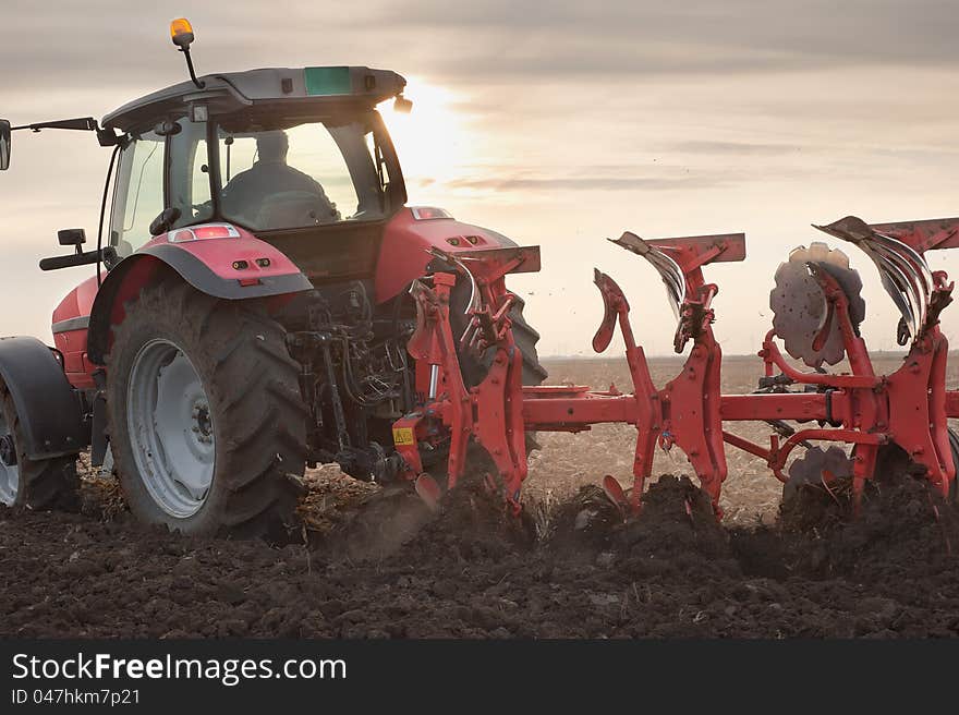 Tractor Plowing In Sunset