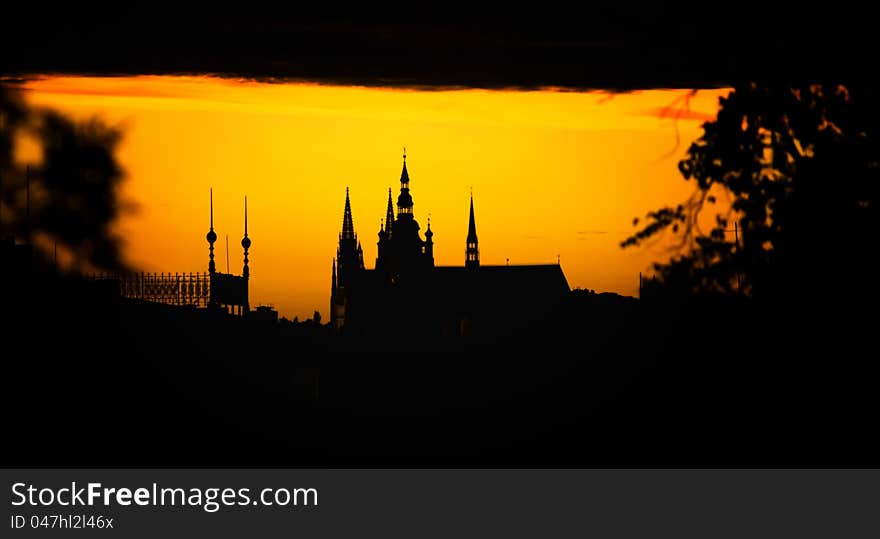 Silhouette of the cathedral in Prague on the golden background