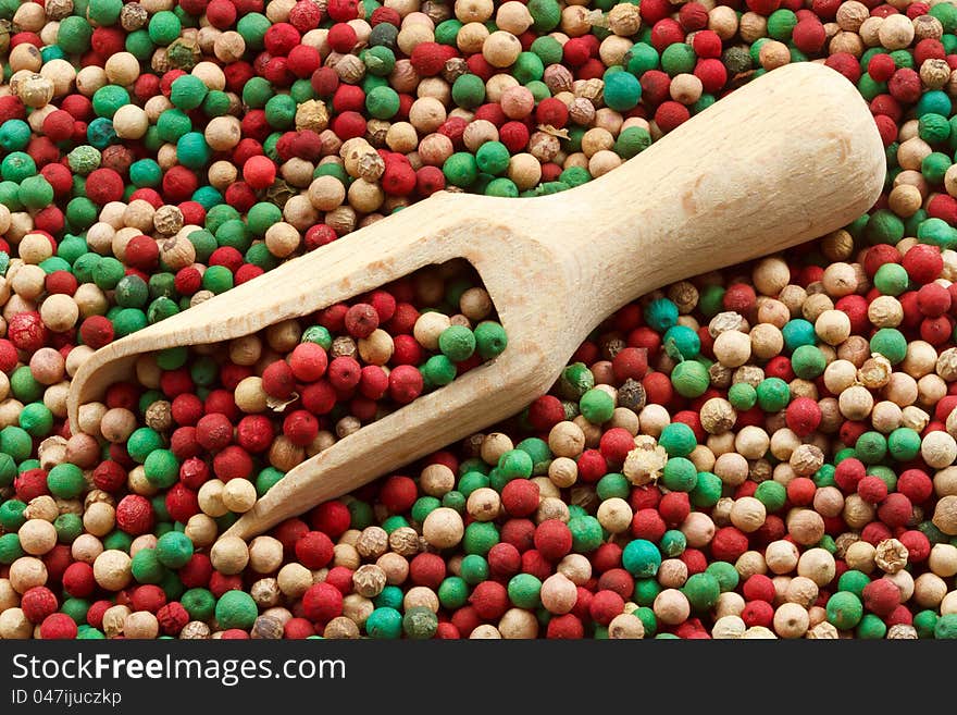 Colorful peppercorns mix, wooden scoop