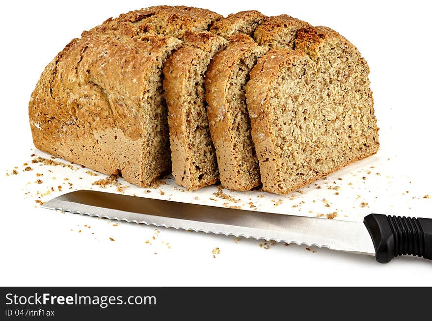 A Loaf Of Bread With A Three Slices And A Knife