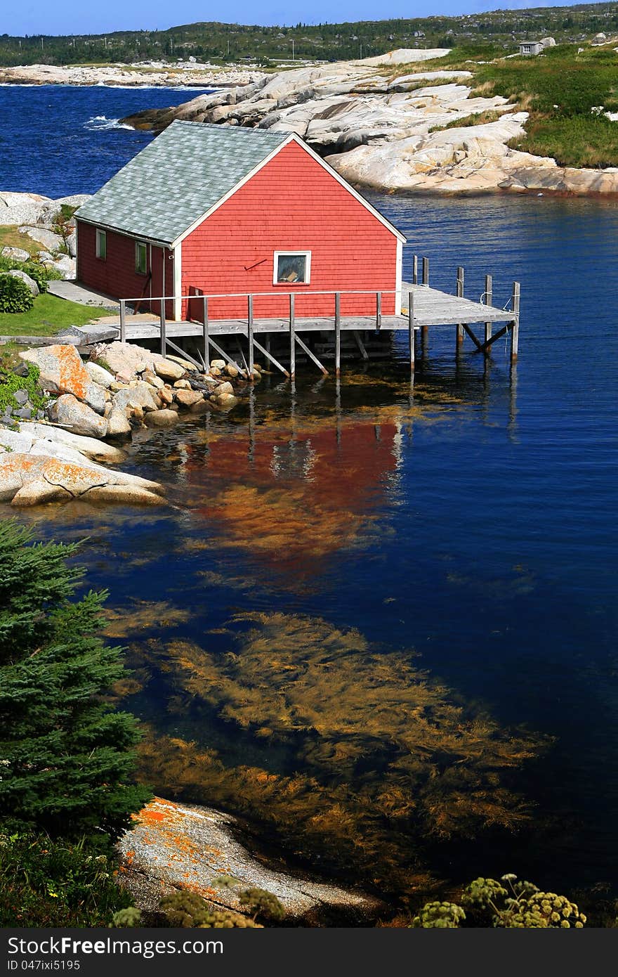 A red house on the blue cove,peggy'cove,Navoscotia,Canada. A red house on the blue cove,peggy'cove,Navoscotia,Canada