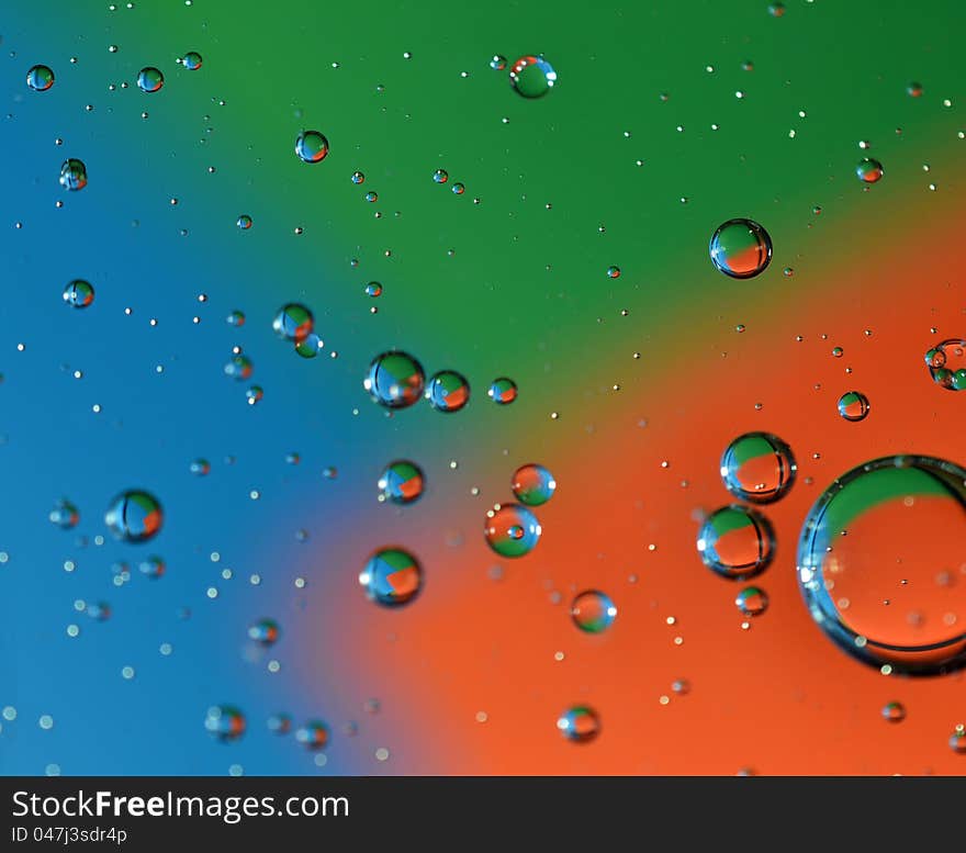 Color photo of bubbles at varying degrees of distance from viewer on multicolor background. Color photo of bubbles at varying degrees of distance from viewer on multicolor background