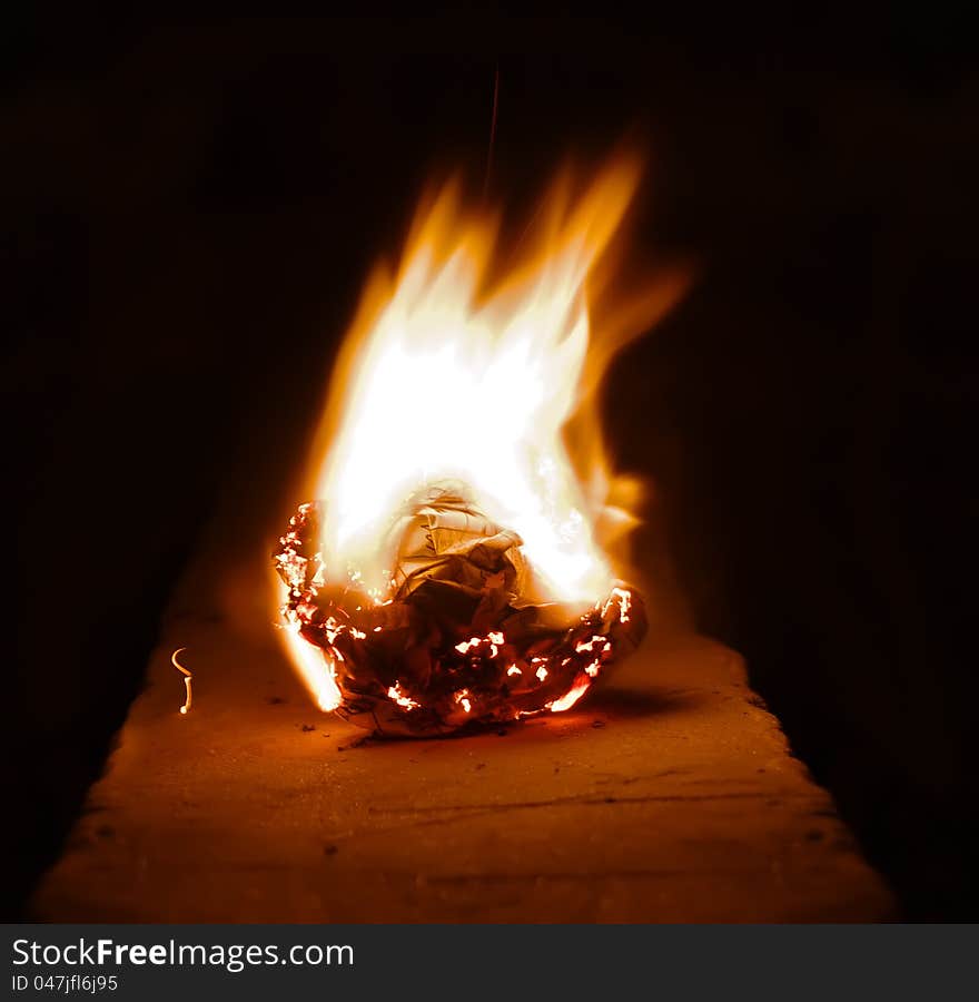 Burning paper photos at night