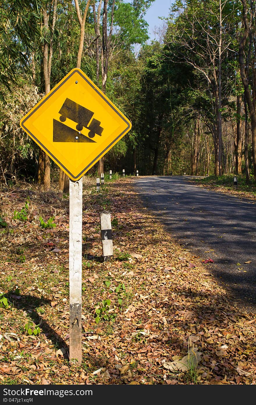 Yellow traffic sign in the tropical forest. Yellow traffic sign in the tropical forest