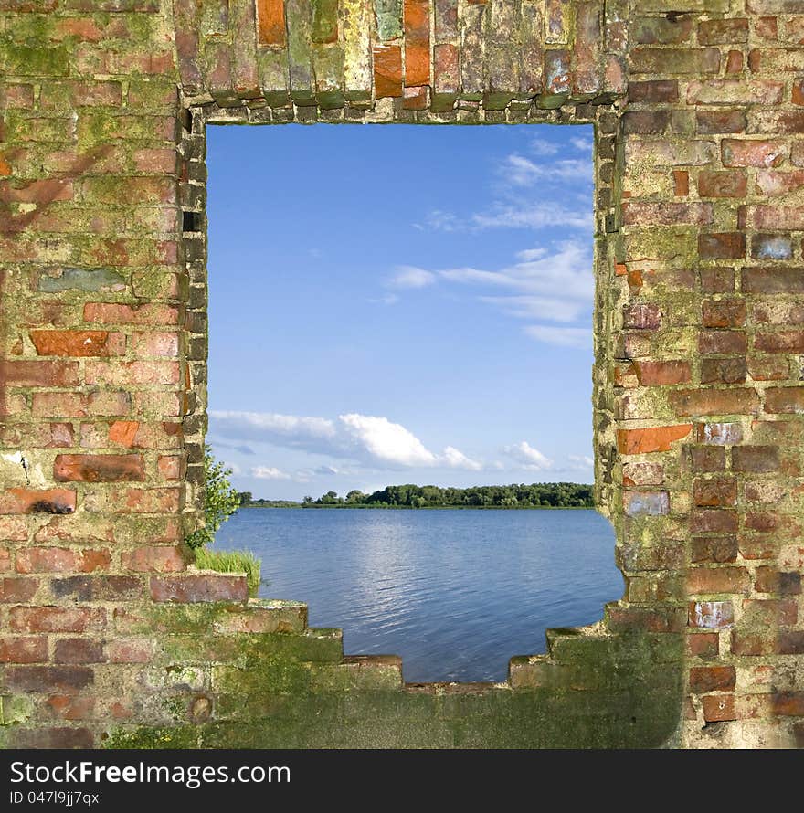 Window in the broken brick wall with a kind on the river. Window in the broken brick wall with a kind on the river