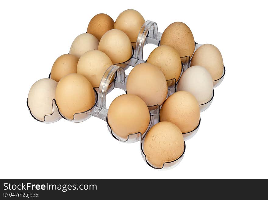 Chicken eggs in a container on a white background.