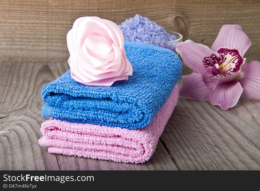 pink and blue bath spa accessory over a wooden background. pink and blue bath spa accessory over a wooden background