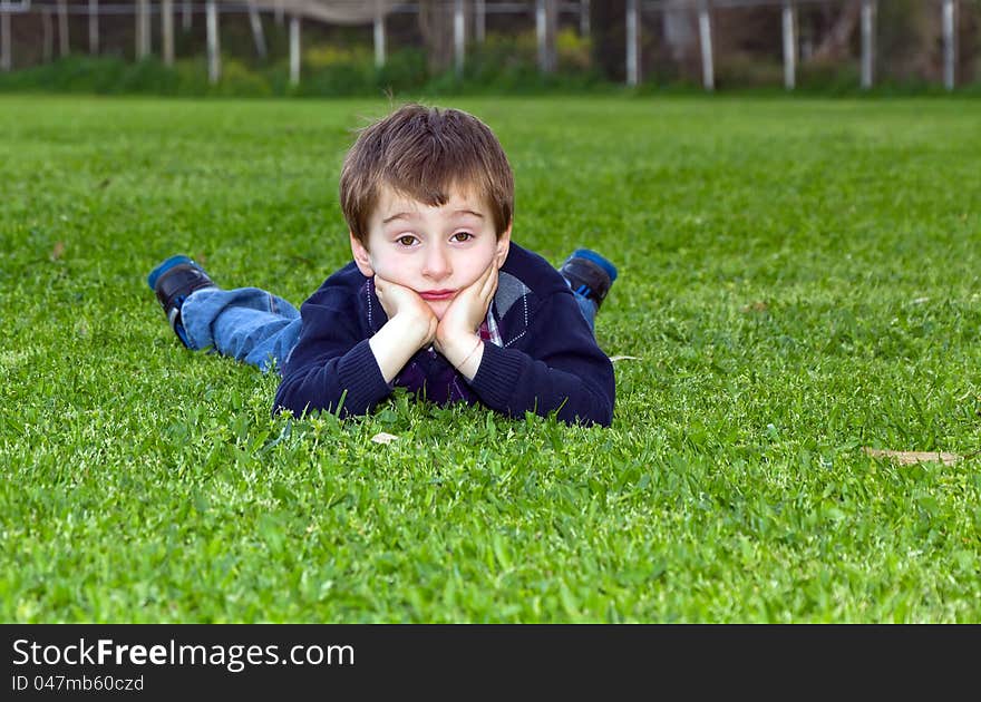 A shot of 5 year old cute child lying on grass