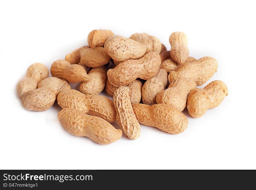 Pile of groundnuts on a white background