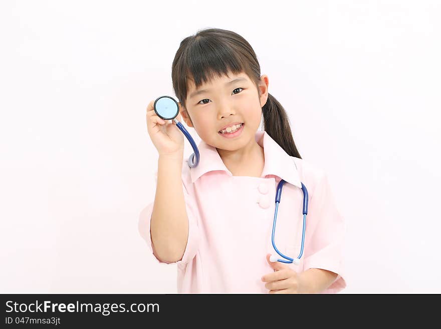 A young asian girl playing dress up as a nurse. A young asian girl playing dress up as a nurse