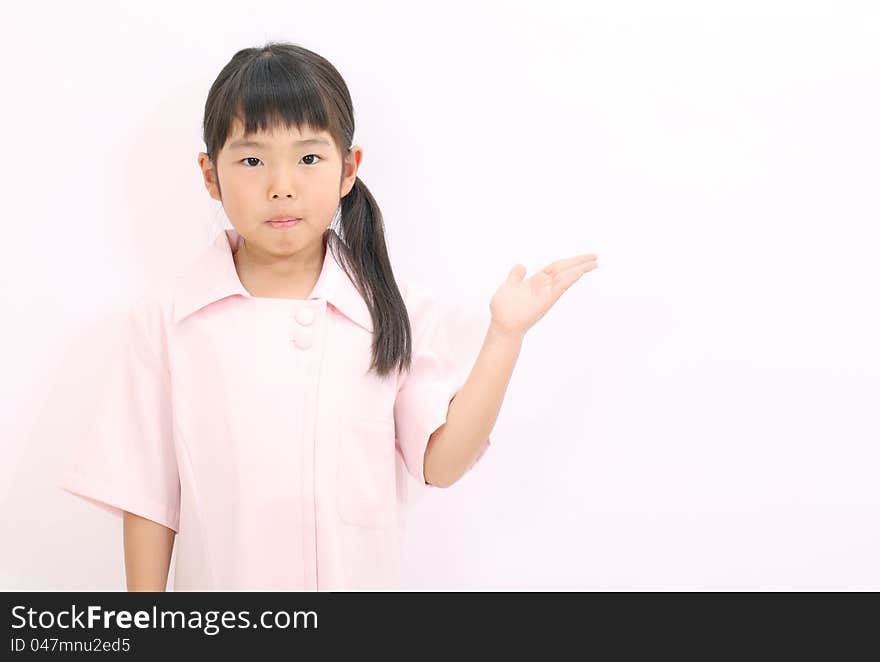 A little girl nurse rise hand showing blank sign