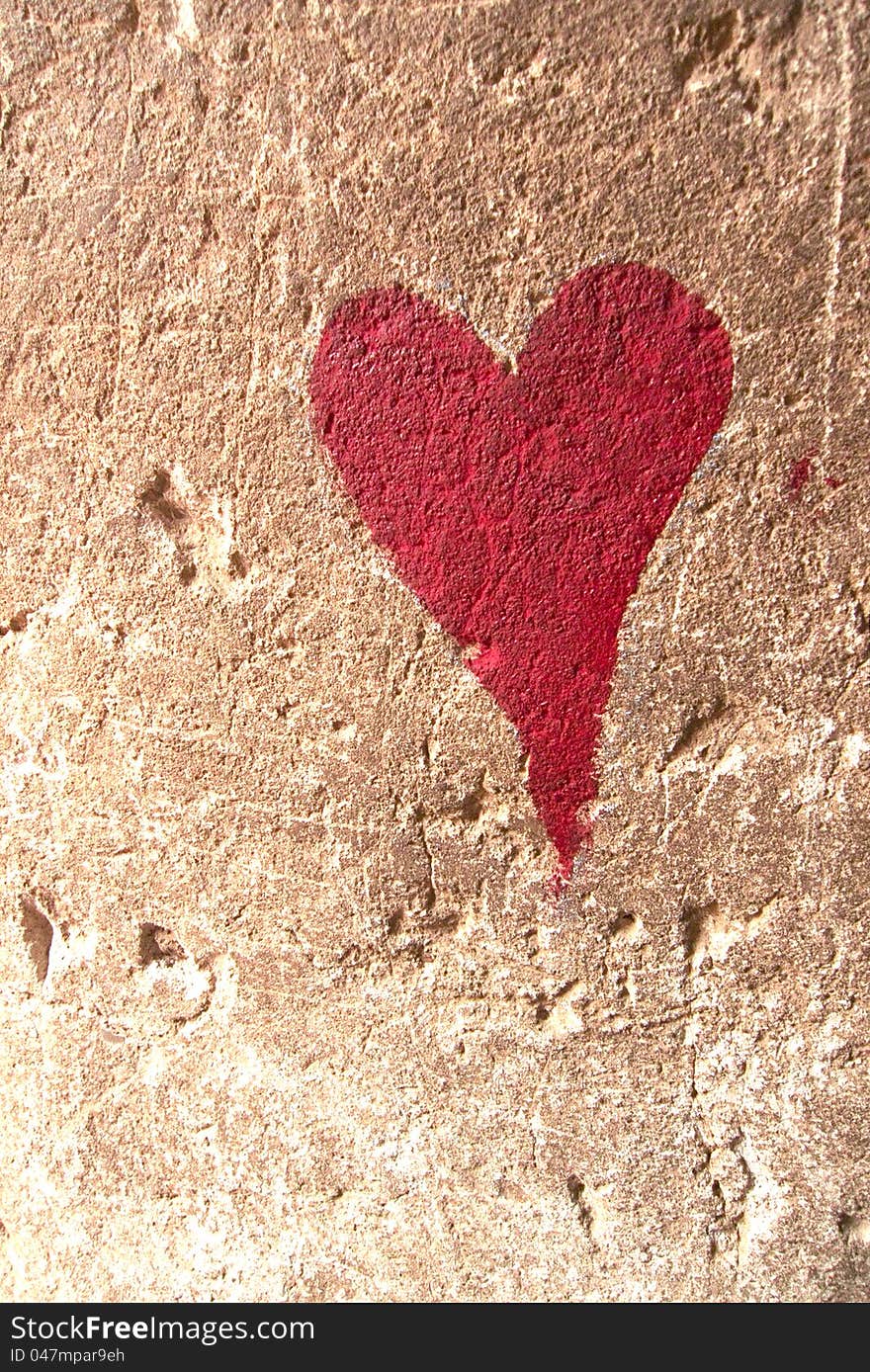 Red heart drawn over brown textured wall. Red heart drawn over brown textured wall