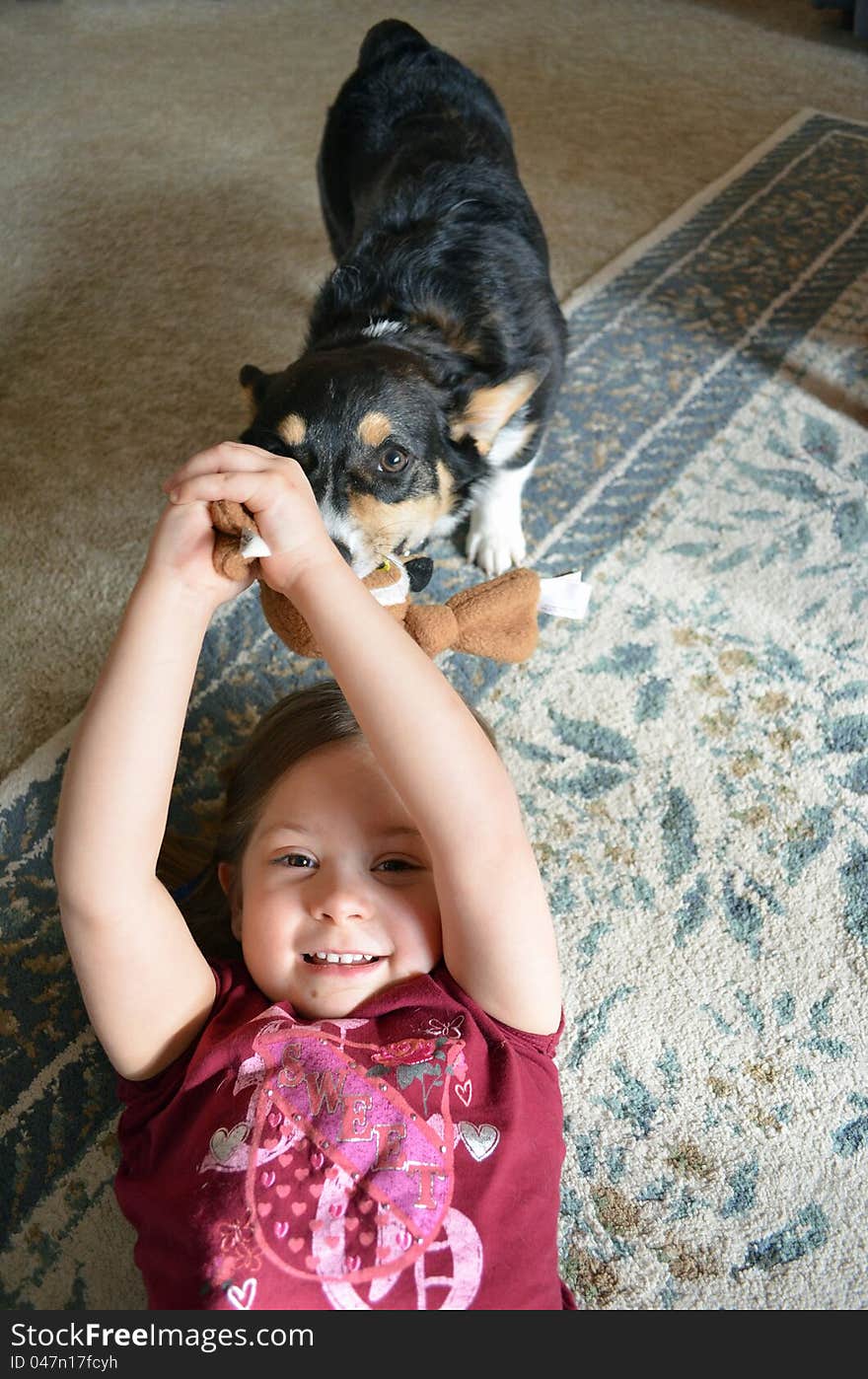 A young girl plays with her dog. A young girl plays with her dog