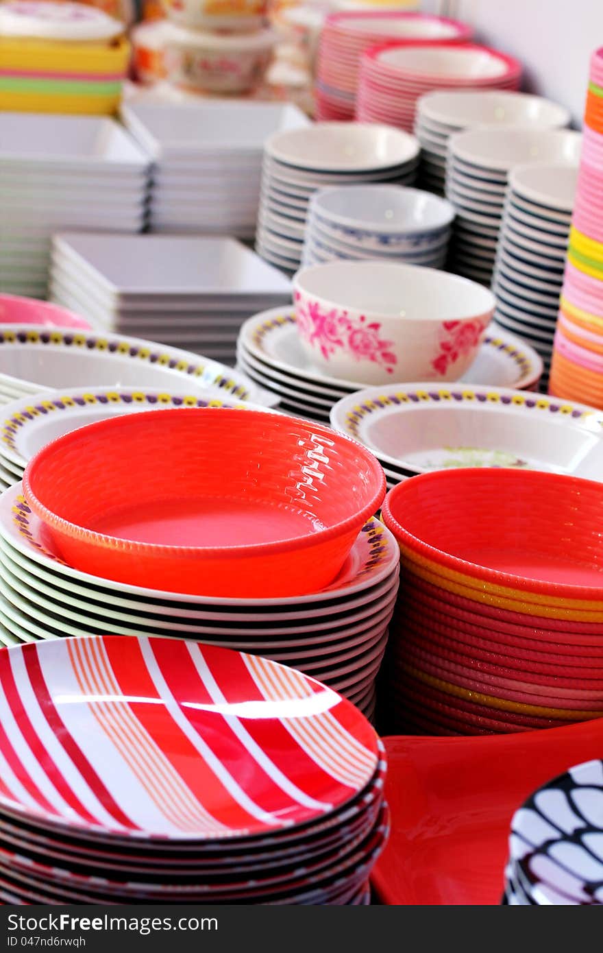 Colorful melamine, ceramic, china clay and plastic bowls arranged for sale in a market. Colorful melamine, ceramic, china clay and plastic bowls arranged for sale in a market