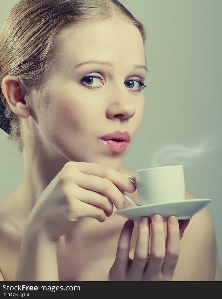 Beautiful girl enjoying  cup of coffee