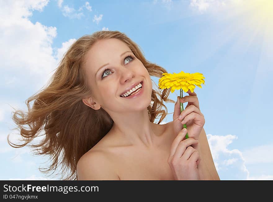 Beautiful girl with flowing hair, yellow gerbera