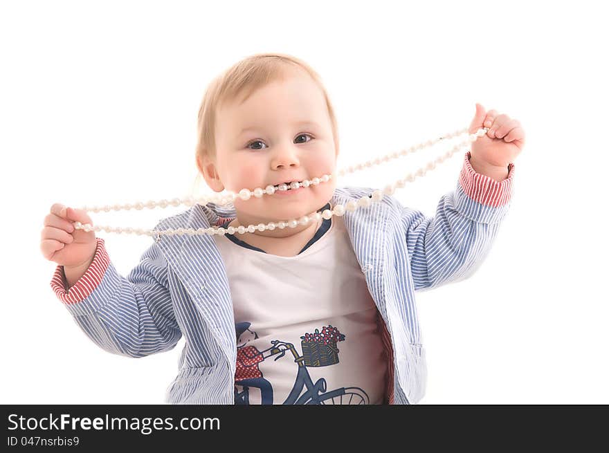 Little girl with pearl beads in his hands and mouth on the white backgraund. Little girl with pearl beads in his hands and mouth on the white backgraund