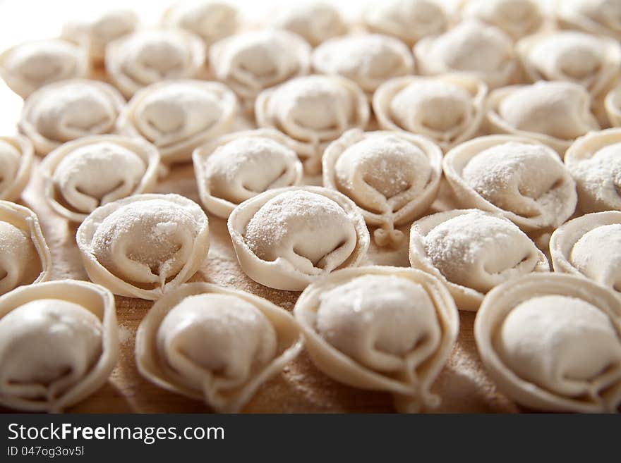 Some raw dumplings on the wooden board